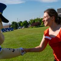 Louie shaking hands with woman in red top